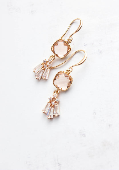 Peach Blush Glass with Crystal fan drop Earrings laying on a white background. Gold and glass earrings with Nickel free and hypoallergenic ear wires. 